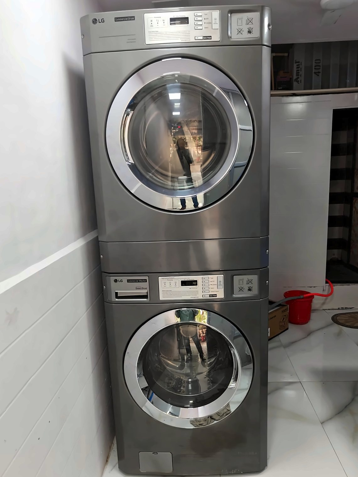 LG commercial washer and dryer stacked inside the Freshfolds laundry shop in Mira Road East